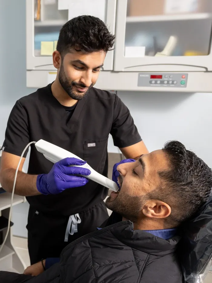 Big City Dental dentist taking a digital scan of a patient's teeth