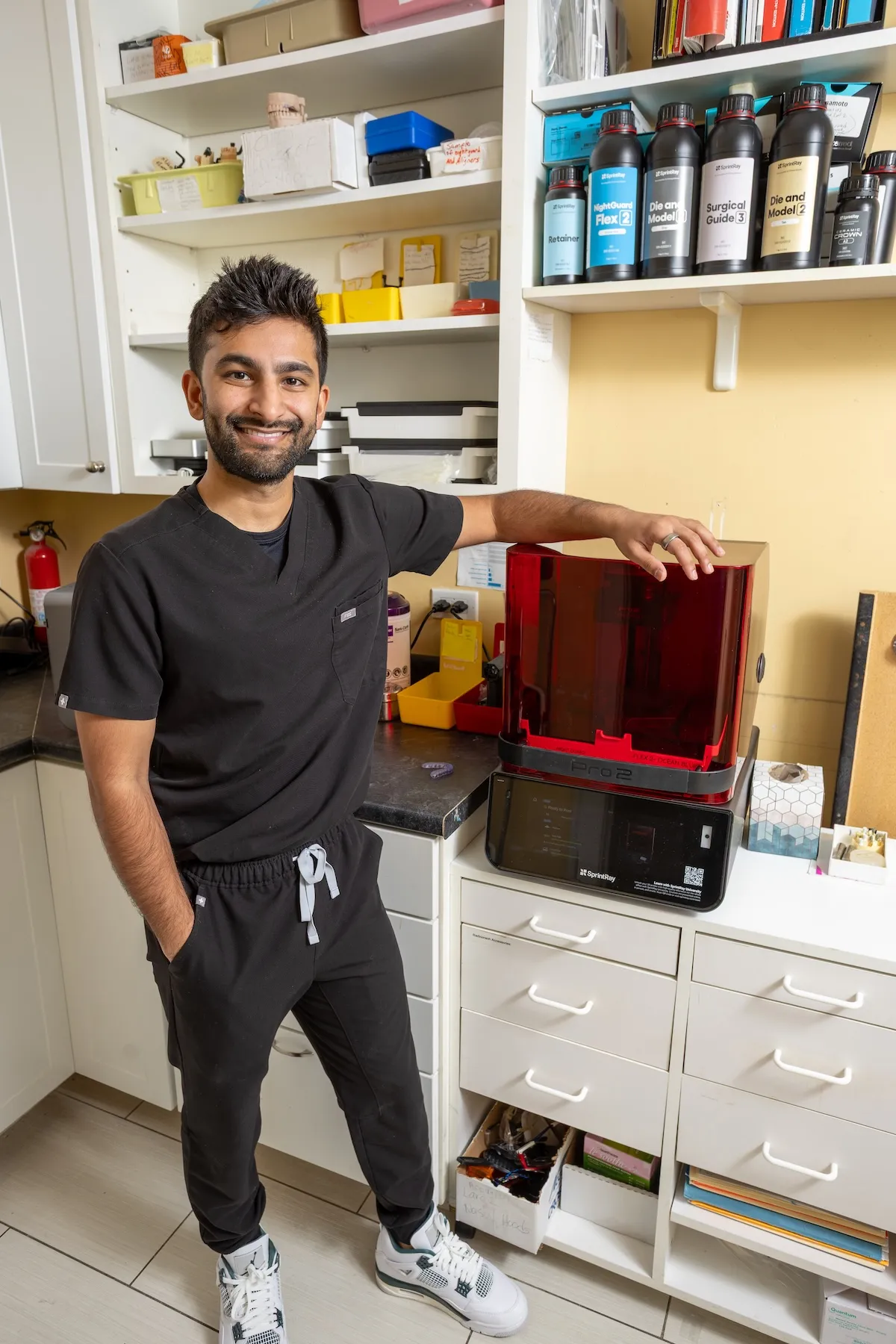 Big City Dental dentist beside the in-office 3D printer