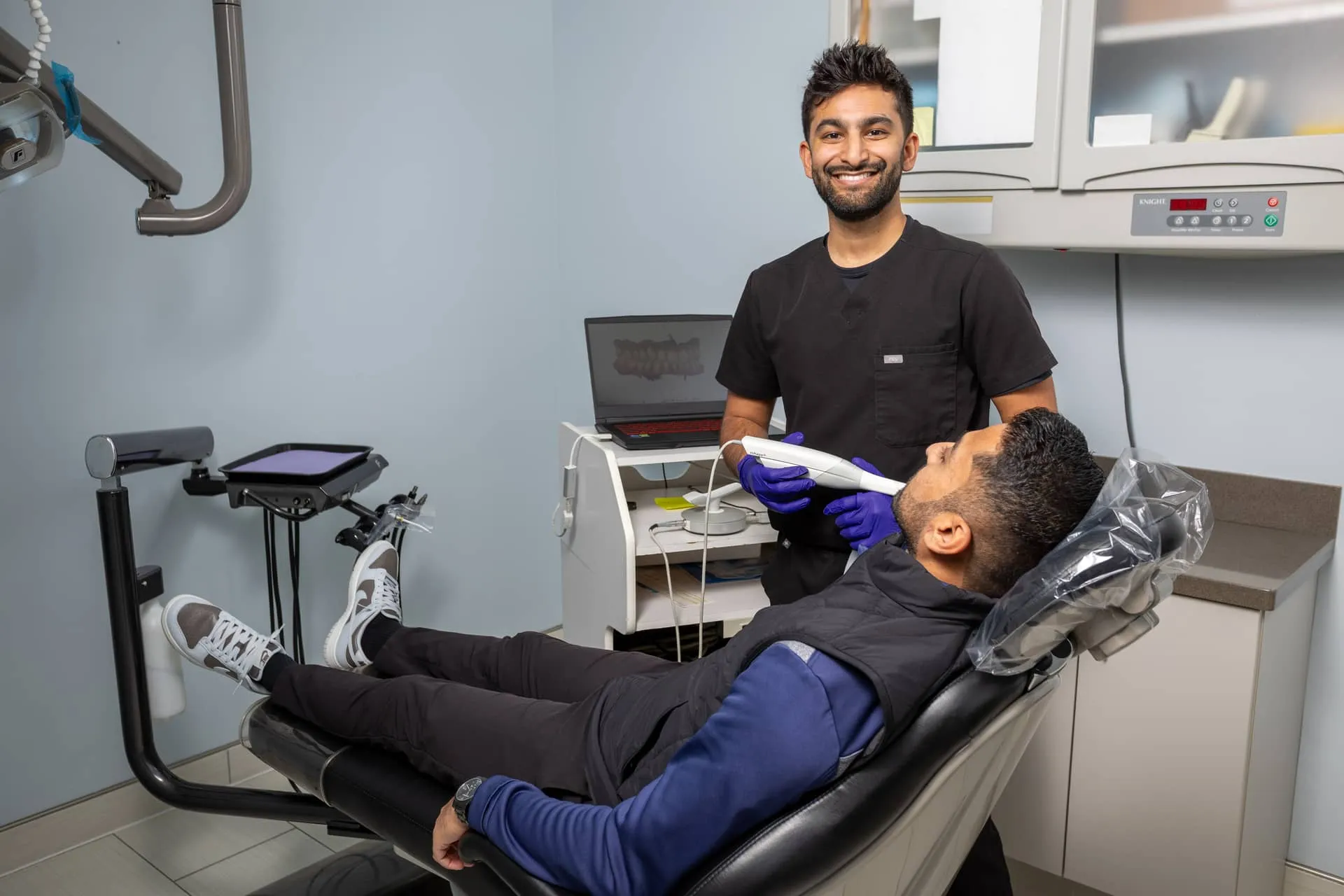 Big City Dental dentist with a patient in the treatment chair